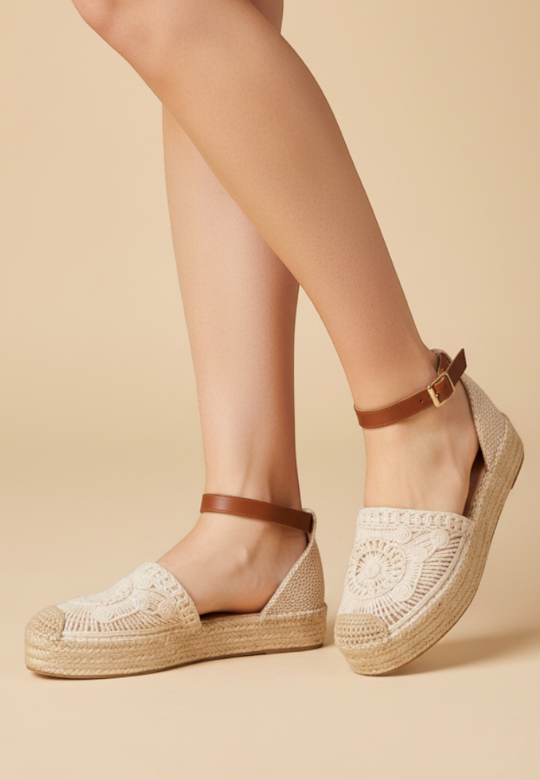 Falio beige platform espadrille sandals with crochet detailing and brown ankle straps on a model