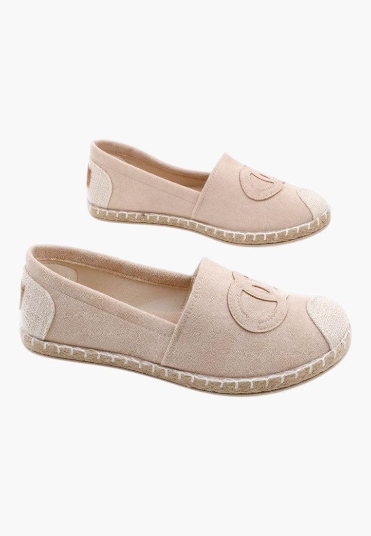 Front view of beige slip-on shoes with a soft material on a white background