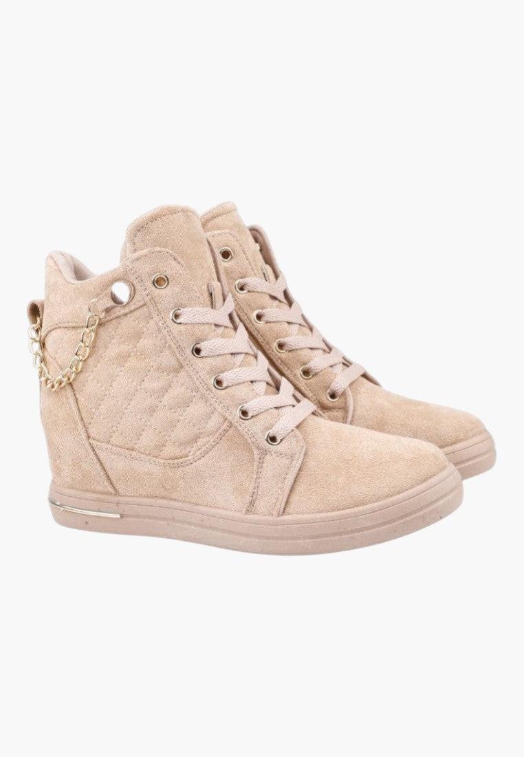 Side view of beige wedge sneakers showcasing lace-up design on a white background