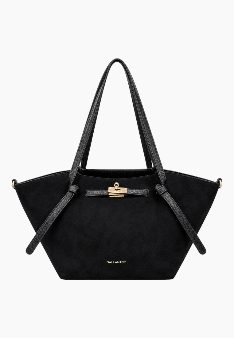 Front view of the black handbag featuring double handles and suede texture.