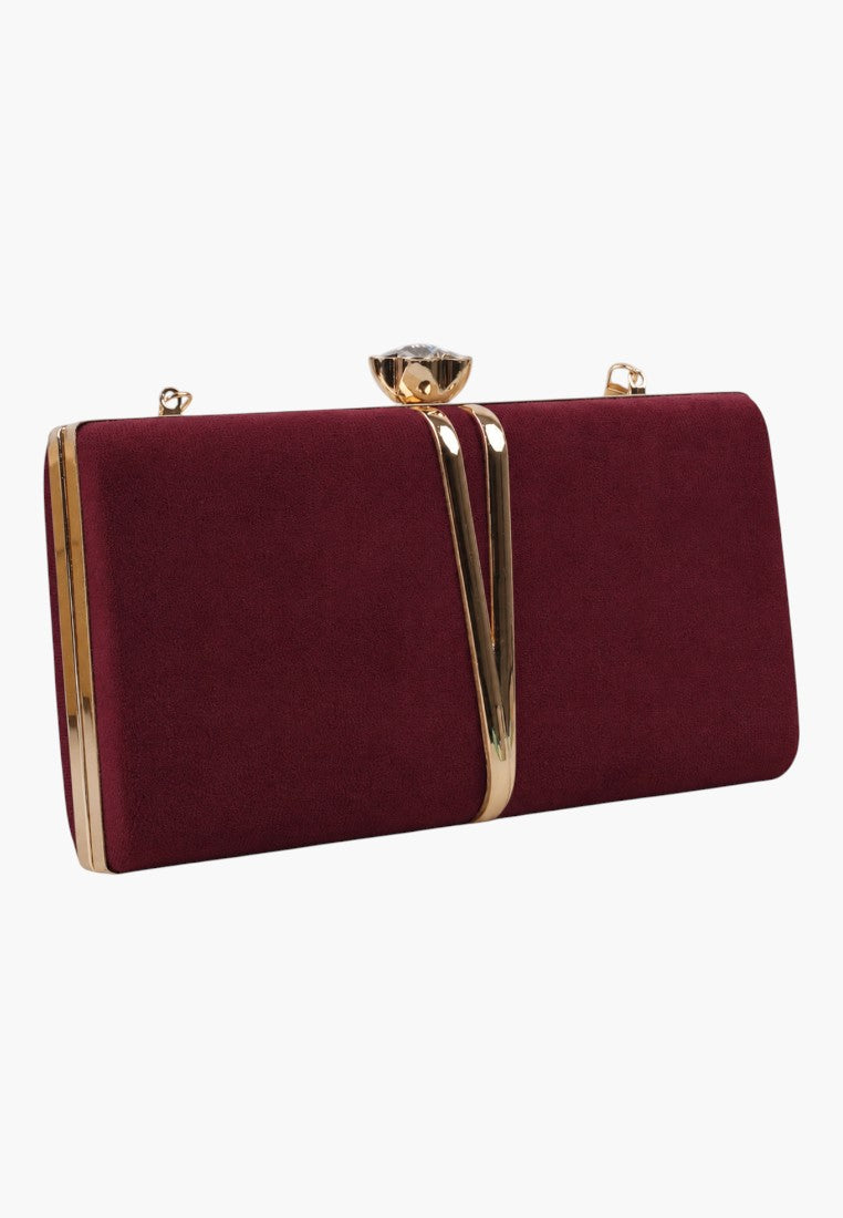Front view of a burgundy clutch bag with a gold clasp on a white background