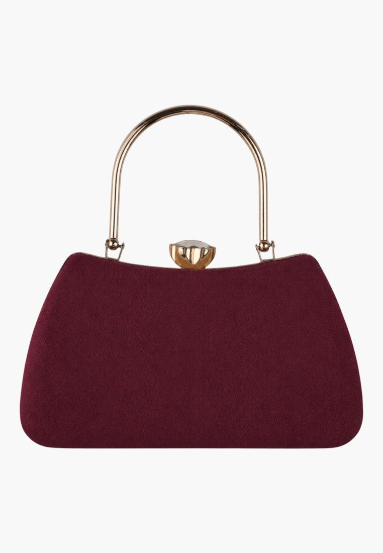Front view of a burgundy handbag with gold hardware on a white background