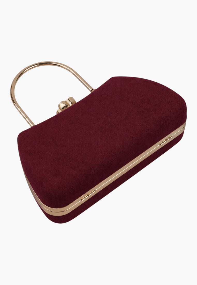 Side view of a burgundy handbag featuring a clasp closure and gold hardware