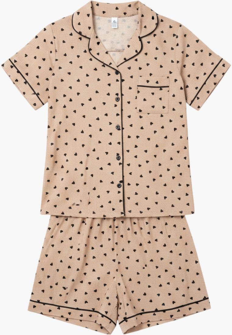 Falio women's beige short pajama set with black heart print, collared neckline, button-up top, and elastic waist shorts.