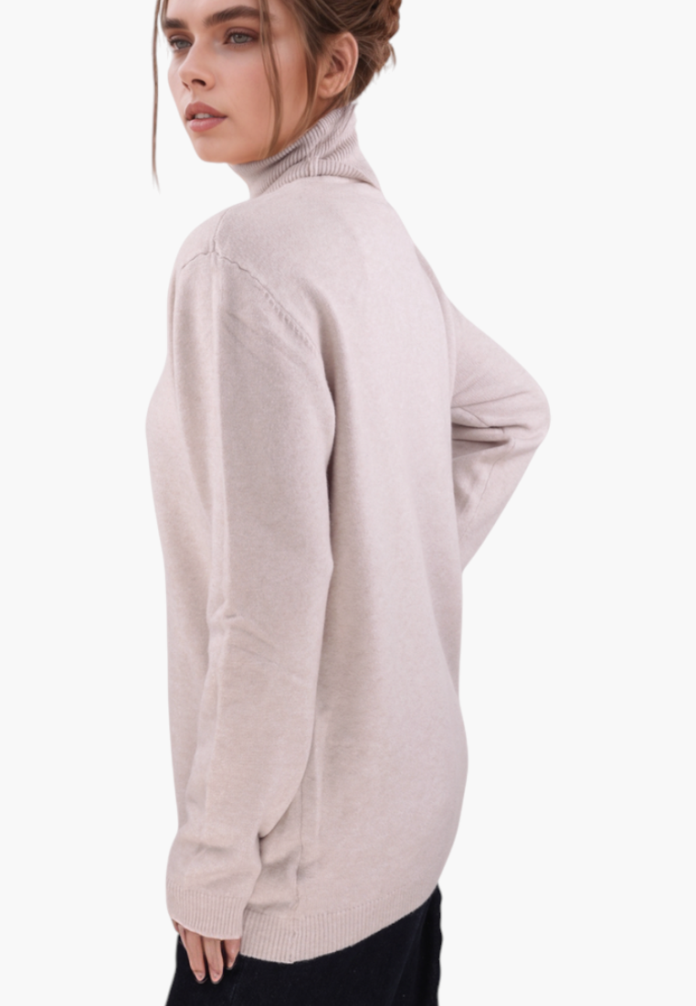 Model wearing a beige Falio viscose mock neck sweater with long sleeves, viewed from the side against a white background