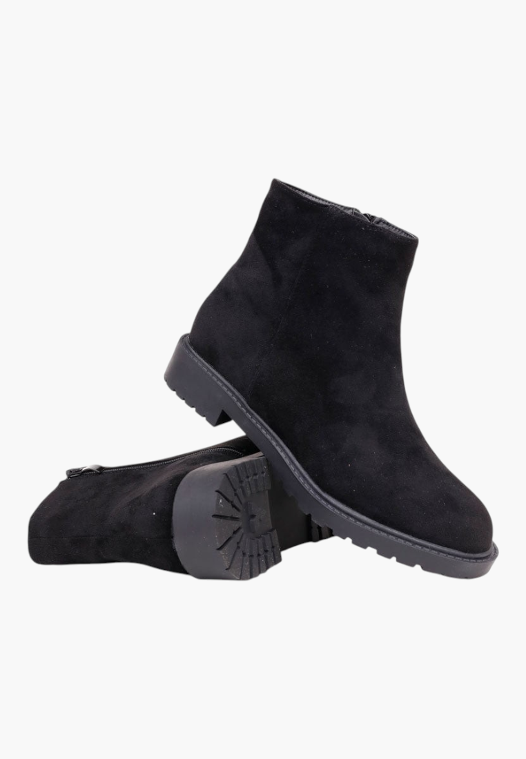 Falio black faux suede ankle boots with a round toe, flat lug sole, and side zipper closure for winter wear.