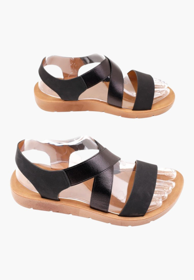 Falio black slip-on sandals with thick soles, featuring faux leather and rubber straps for a comfortable fit.