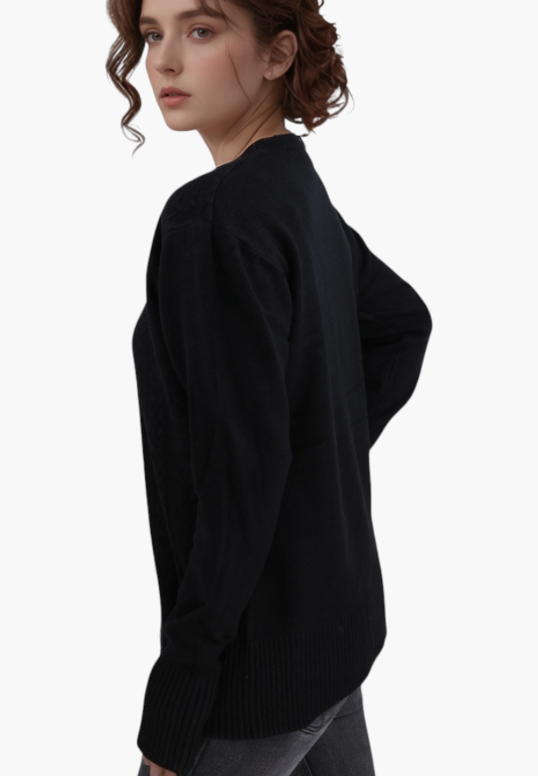 Model wearing a Falio black long-sleeved sweater with a round neckline, crafted from a soft wool and cashmere blend.
