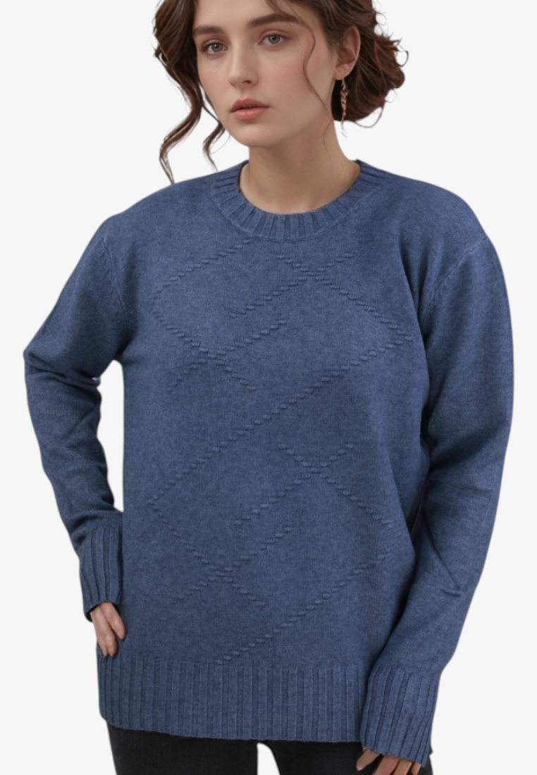 Model wearing a blue Falio crew neck sweater with a subtle diamond knit pattern in a soft wool and cashmere blend.