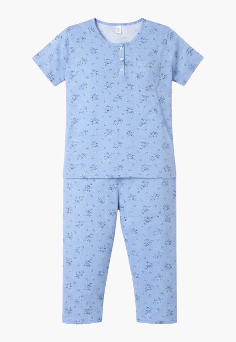 Falio light blue 100% cotton women's plus size pajama set with short sleeves, round neck, button front, and floral print. Includes capri pants with a pocket.