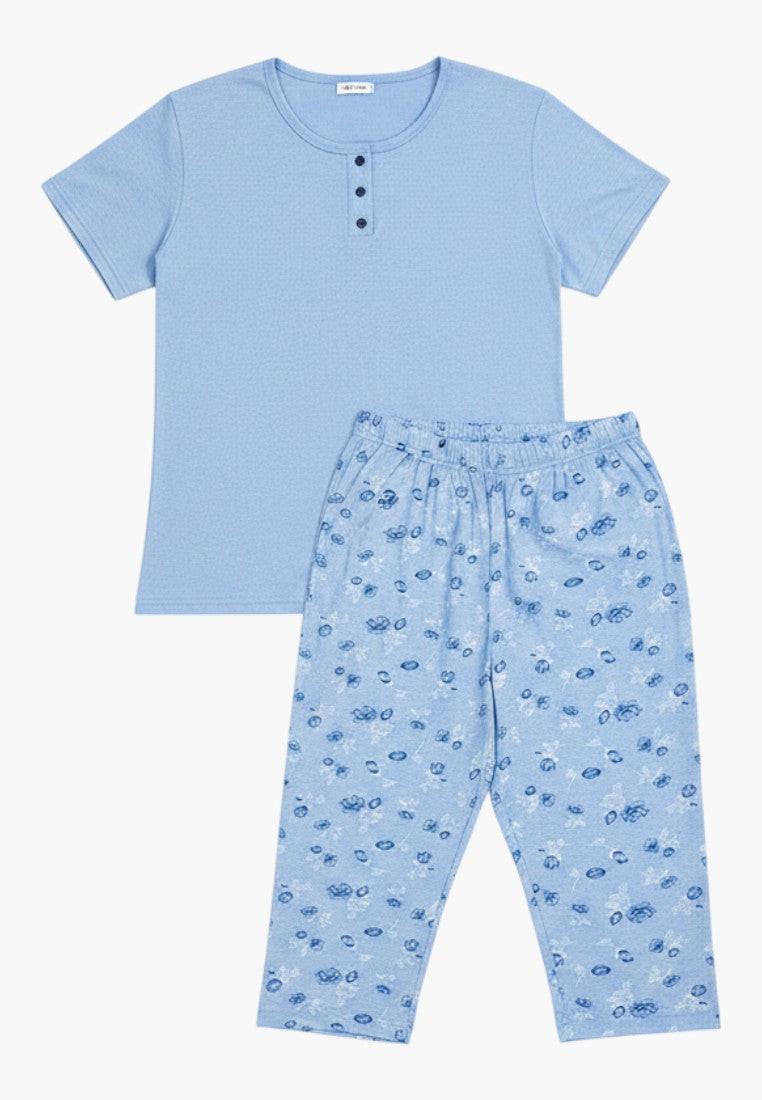 Falio women's blue cotton pyjama set with short sleeves and floral print capri pants. Round neck with button detail.