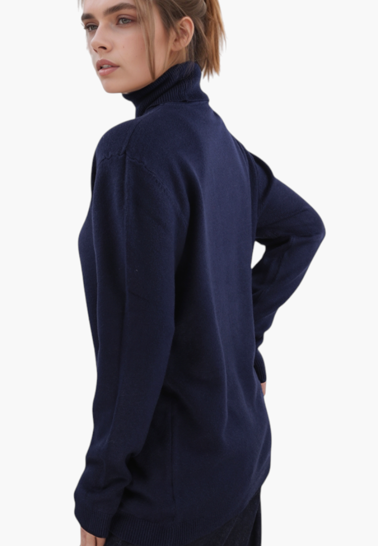 Falio blue viscose blend turtleneck sweater with long sleeves worn by a model in a minimalist studio setting