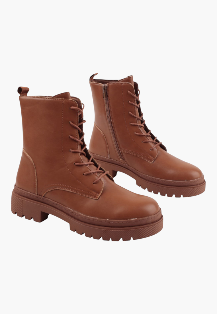 Falio brown faux leather ankle boots with lace-up closure and chunky lug soles for a stylish autumn look.
