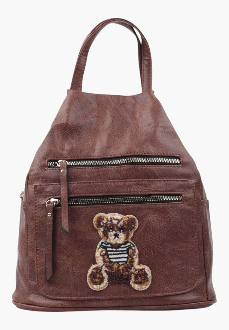 Falio brown faux leather urban backpack with a cute teddy bear patch and multiple zippered pockets