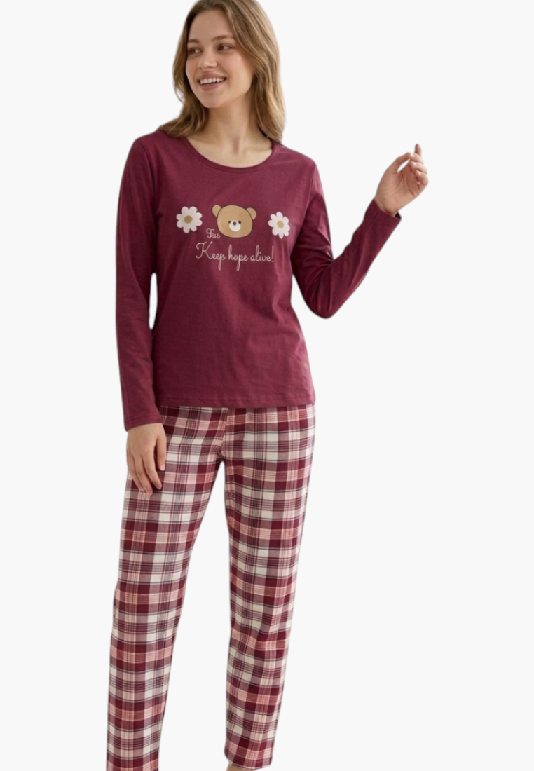 Model wearing a Falio long-sleeve cotton pajama set with a maroon top featuring a bear print and plaid bottoms.