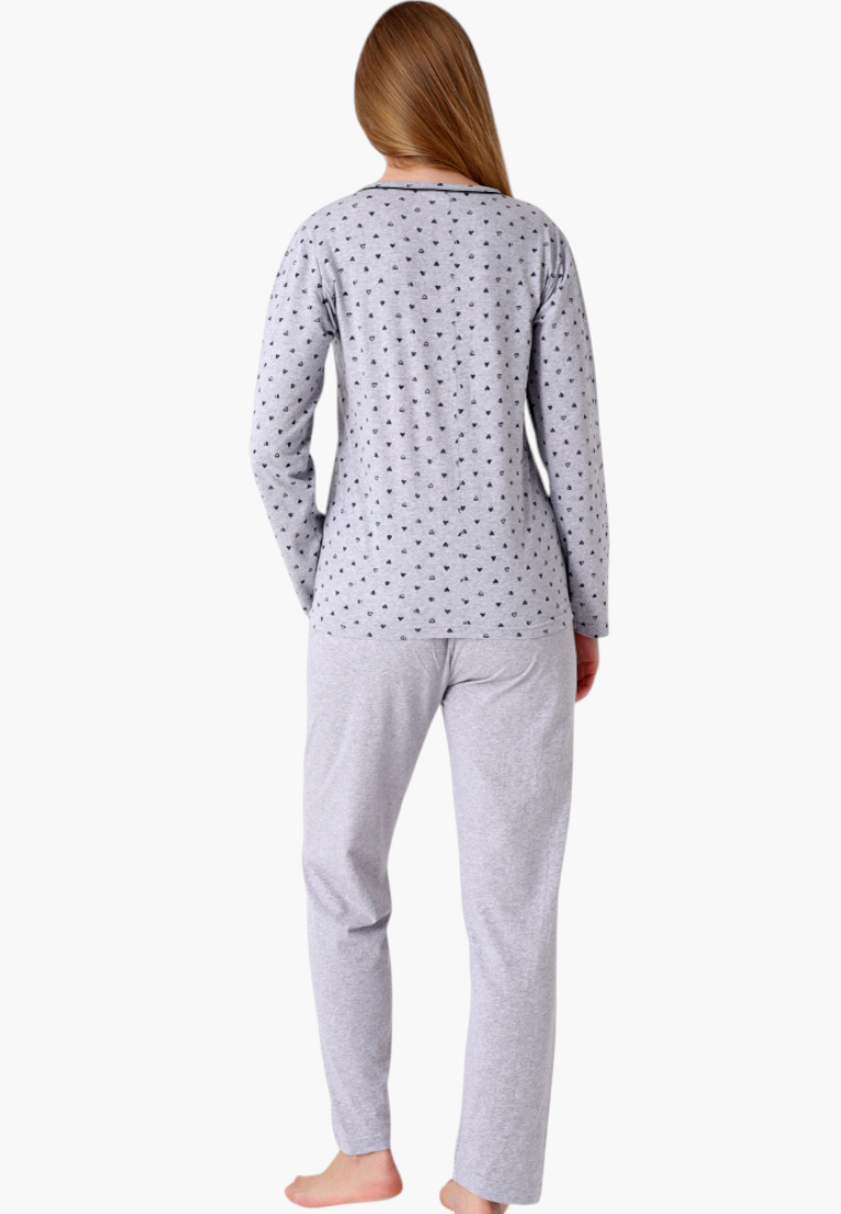 Woman wearing a Falio long-sleeved grey cotton pajama set with a small heart pattern, viewed from the back.
