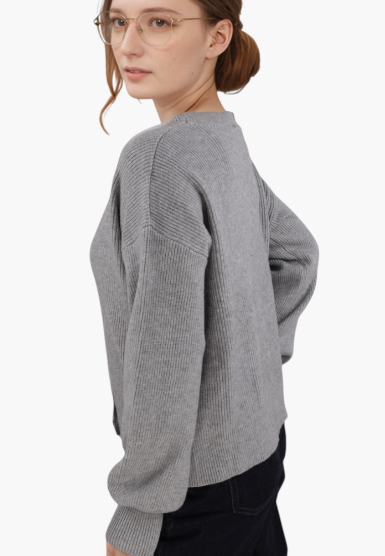 Falio grey ribbed knit sweater with long sleeves and V-neck worn by a woman with glasses