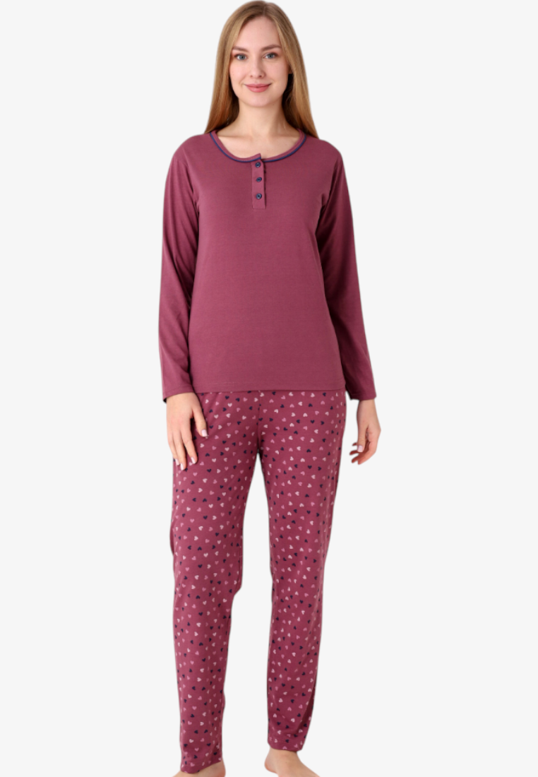 Model wearing a Falio insulated cotton pajama set with a long-sleeved burgundy top and heart-patterned trousers.