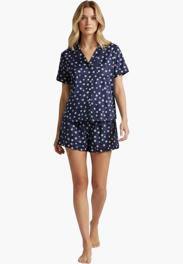 Falio navy blue 100% cotton pajama set with white floral print. Features short sleeves, notched collar, button-up top, and elastic waist shorts.