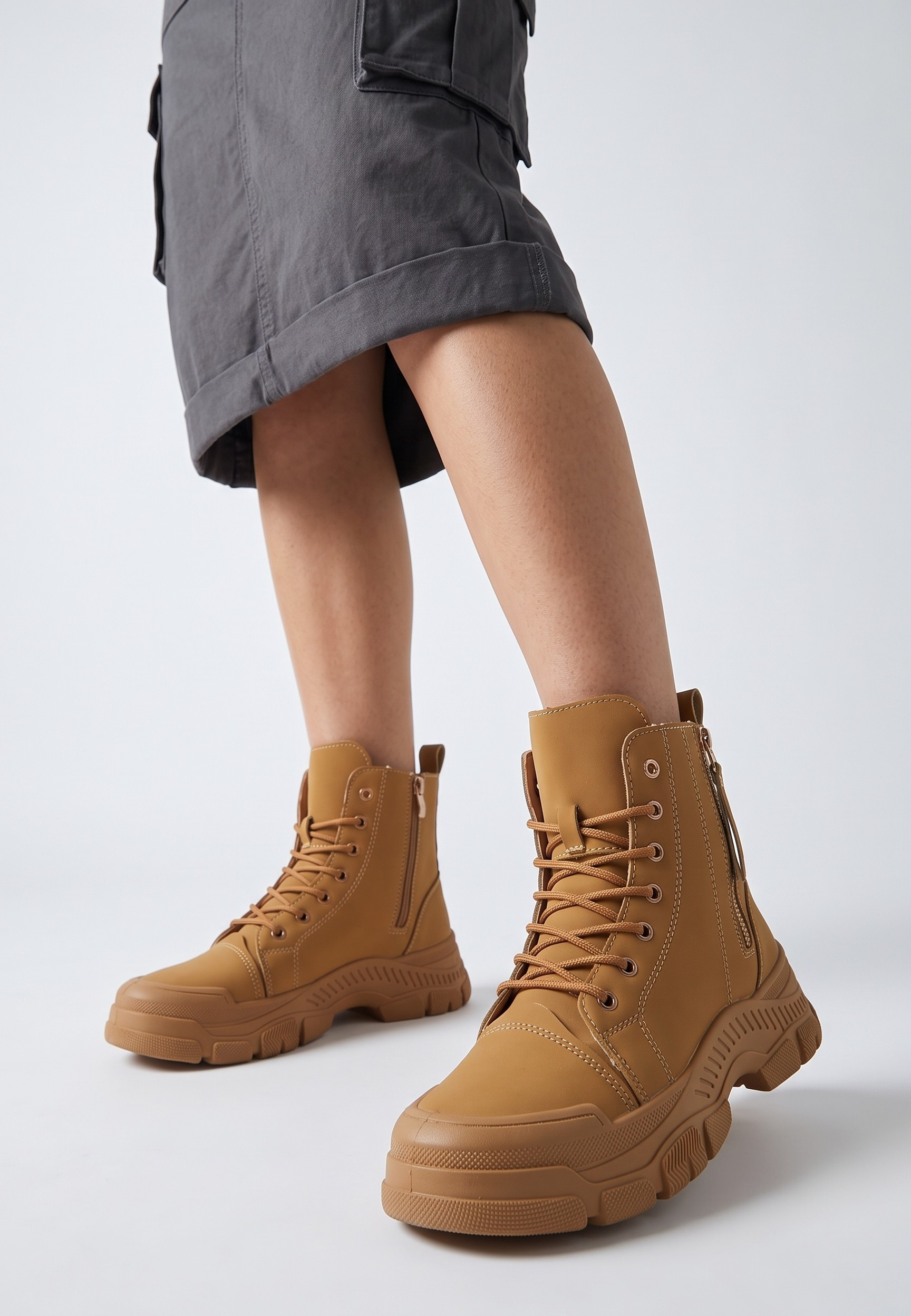 Falio tan synthetic nubuck lace-up ankle boots with chunky tread soles worn with a grey skirt