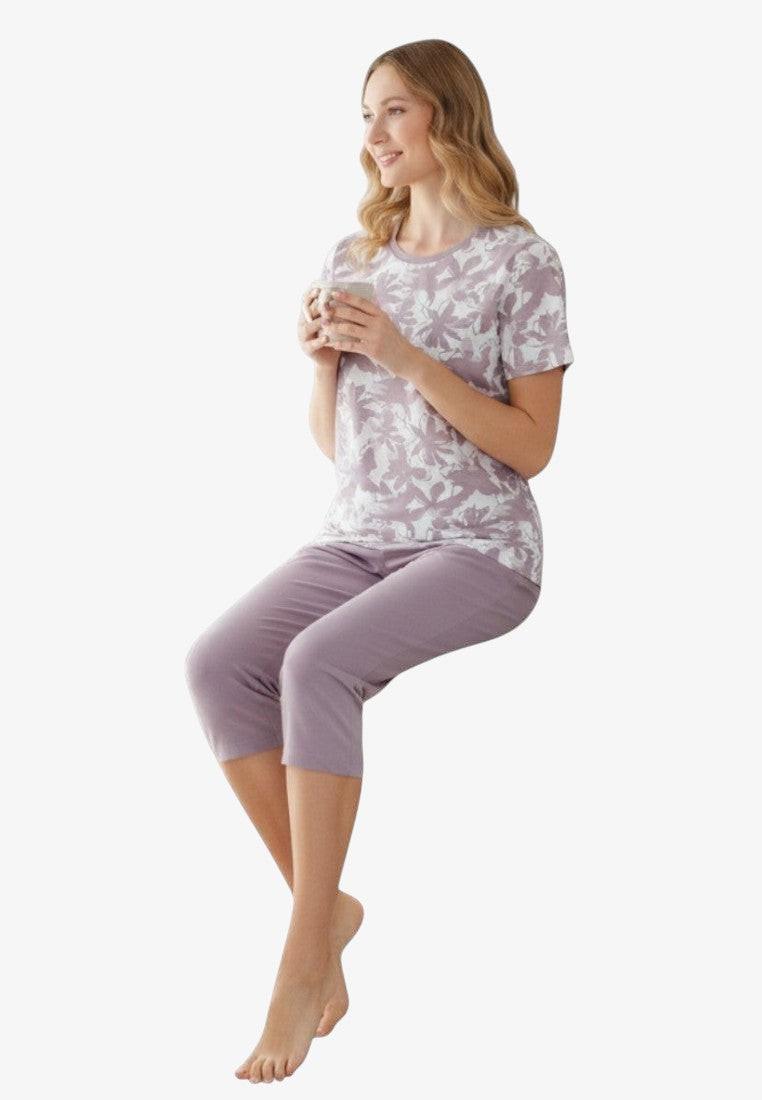 Falio women's two-piece pajama set with a floral print t-shirt and solid lilac 3/4 length pants, made of 100% cotton.