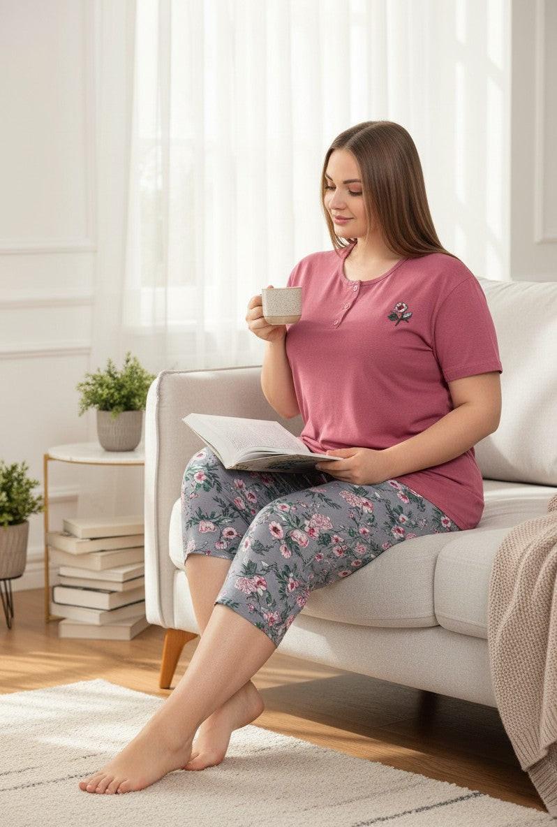 Falio women's plus size 100% cotton two-piece pajama set. Rose pink short-sleeve top with button detail and floral print capri pants in grey.