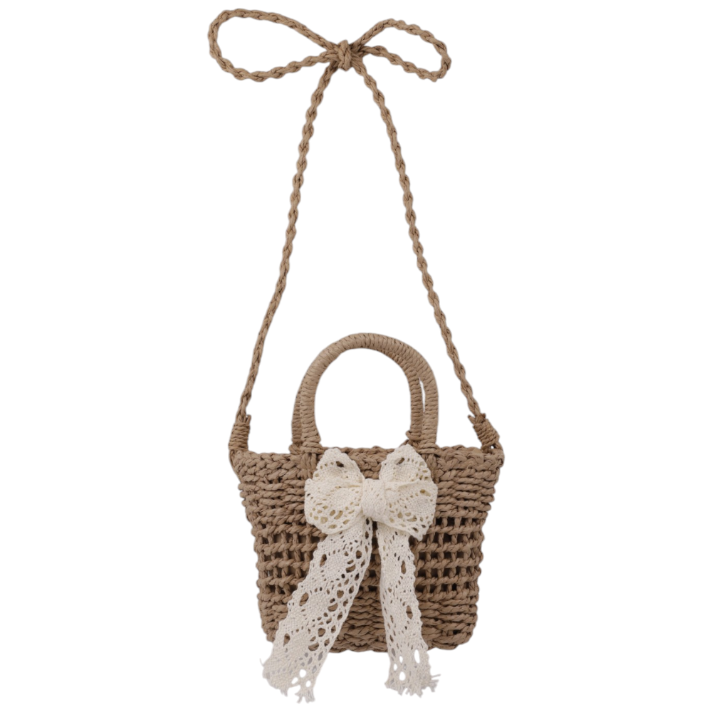 Lifestyle shot of a woven handbag in brown and white with a bow detail.