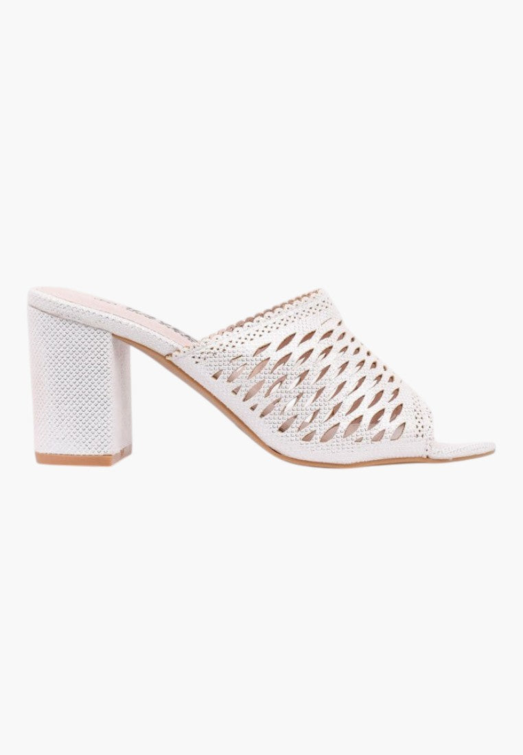 Side view of white heeled sandals featuring open toe and chunky heel on a white background
