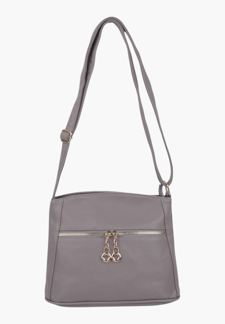 Side view of a gray handbag featuring an adjustable strap and gold hardware.