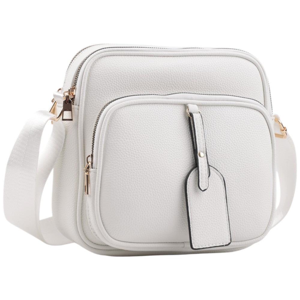 Front view of the white crossbody bag with zipper closure and adjustable strap.