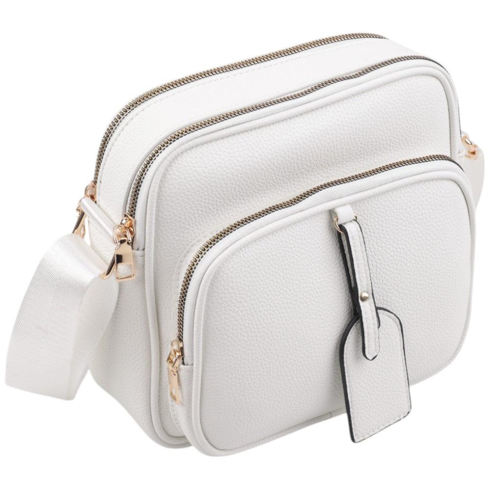 Side view of the white crossbody bag featuring gold hardware and double zipper.