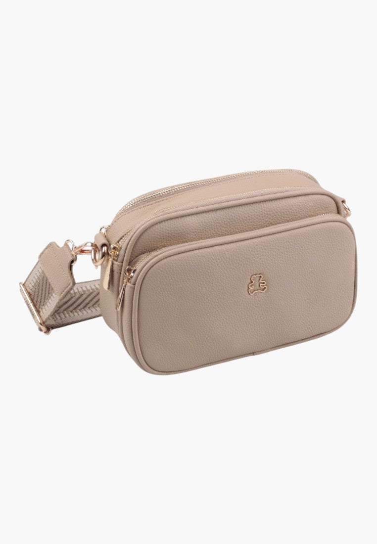 Side view of a khaki crossbody bag featuring a smooth texture and zipper closure.
