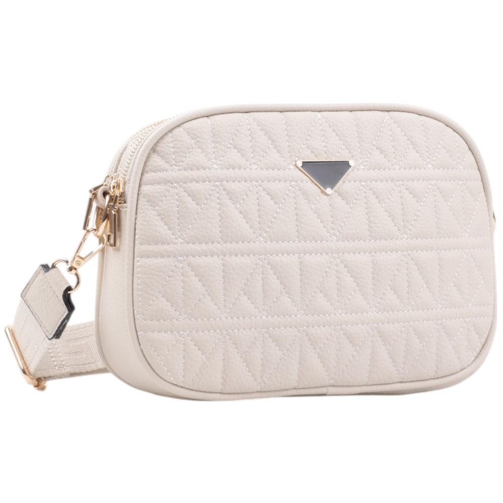 Front view of a cream crossbody bag with quilted texture and gold hardware.