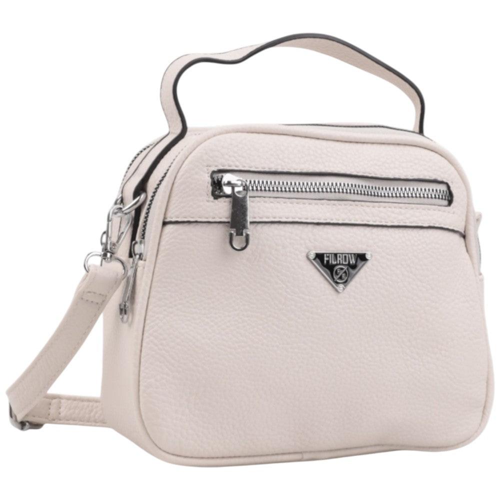 Front view of a light pink handbag with zipper closure and silver hardware.