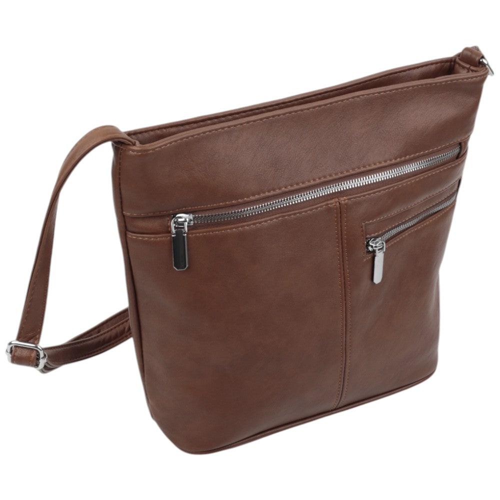 Side view of the brown leather handbag showcasing zipper closure and front pocket.
