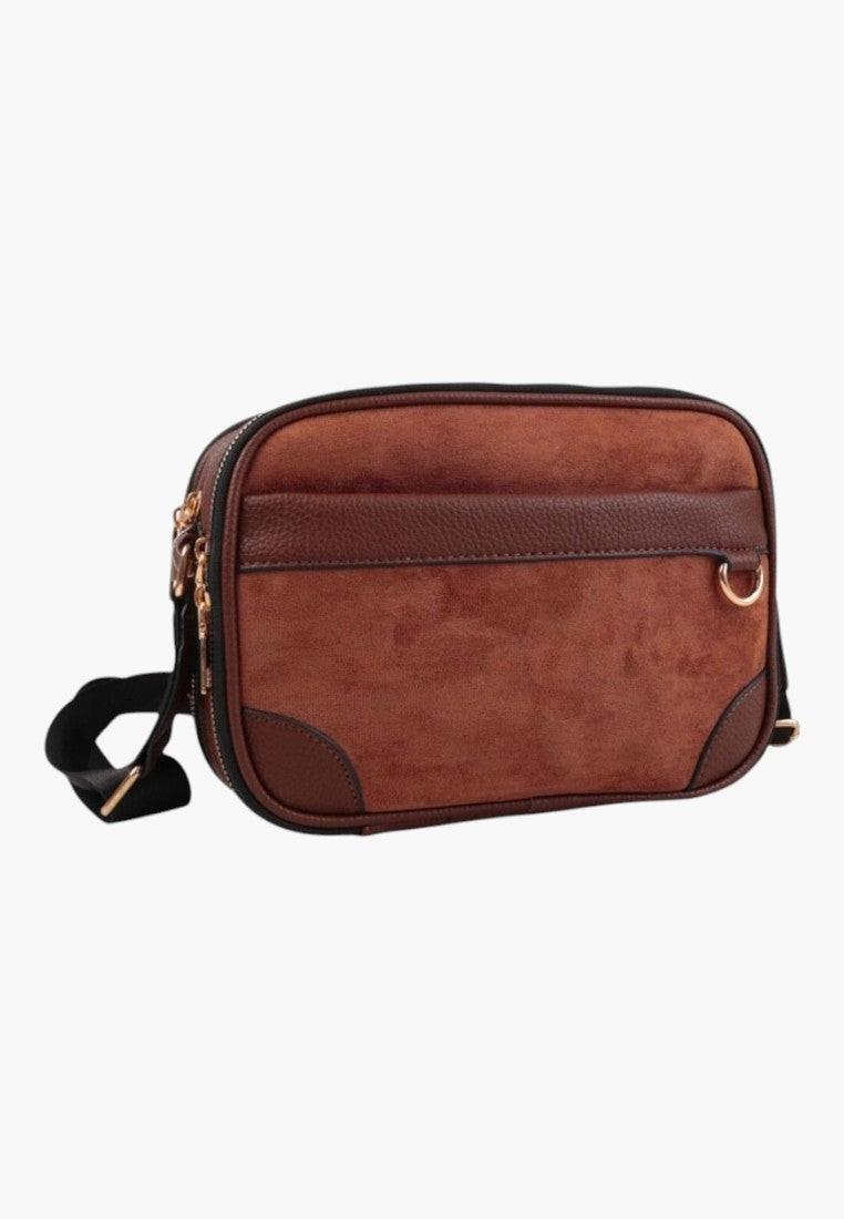 Front view of the brown shoulder bag with zipper closure and front pocket.