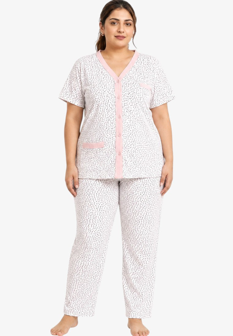 Lifestyle shot of a women's pajama set in white and pink colors with short sleeves.