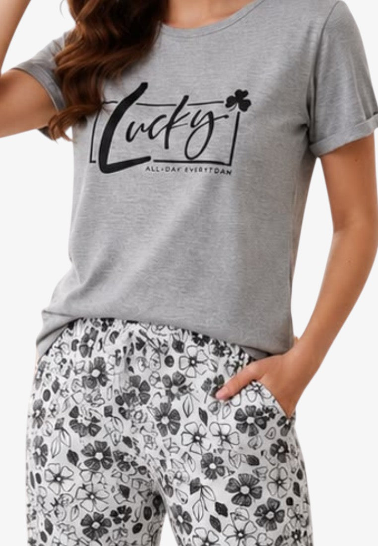 Detail close-up of a women's pajama top showcasing a graphic design with short sleeves in gray and black.