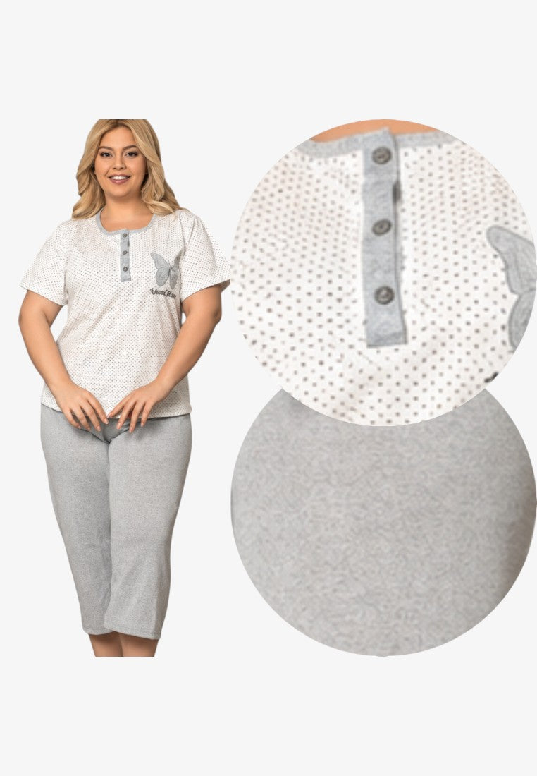 Stylish plus size cotton pajama set with white polka dot top and grey 3/4 pants on a model in natural light.