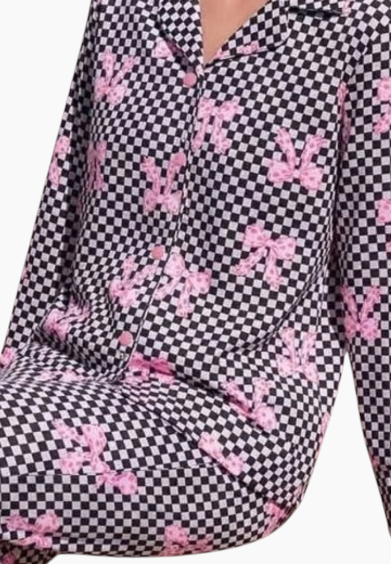 Front view of women's pajamas in gray, pink, and black showcasing a checkered pattern and bow prints.