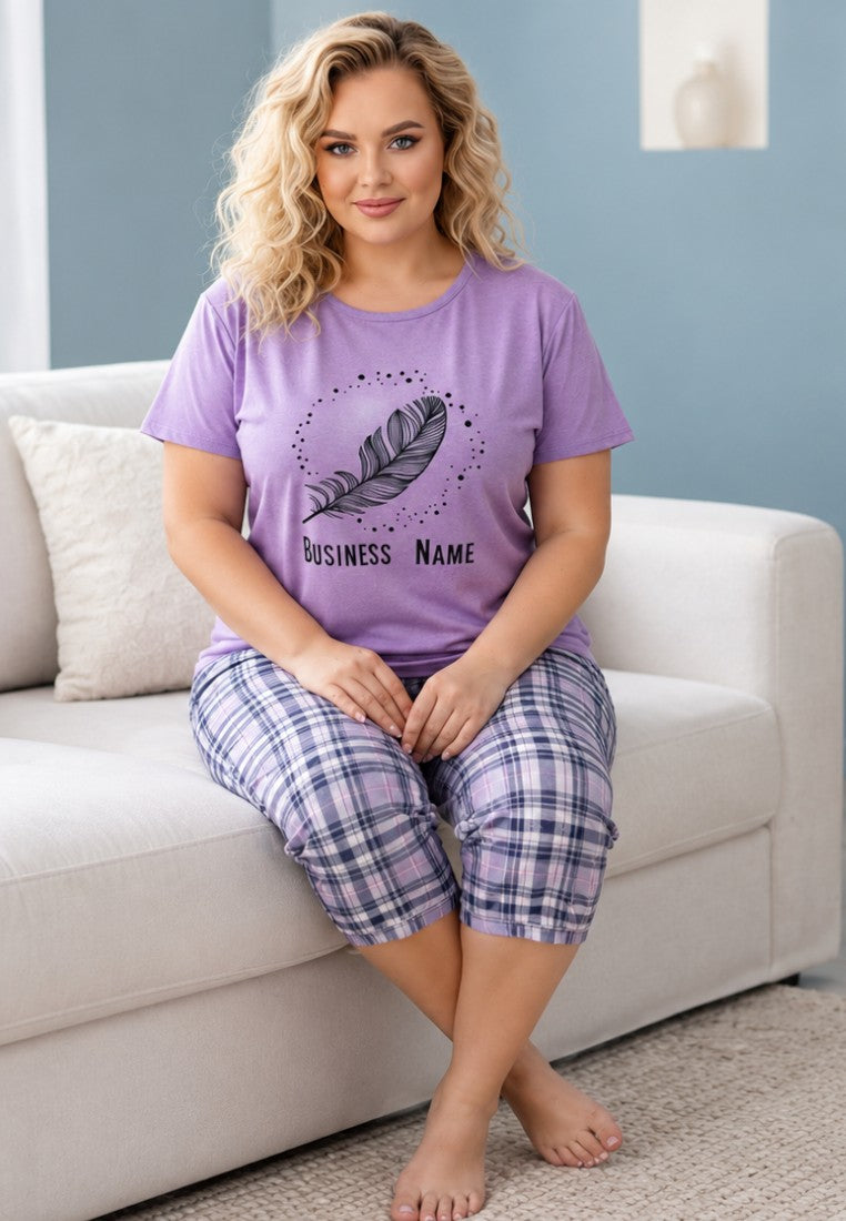 Detail of a woman in a purple graphic t-shirt and plaid pants.