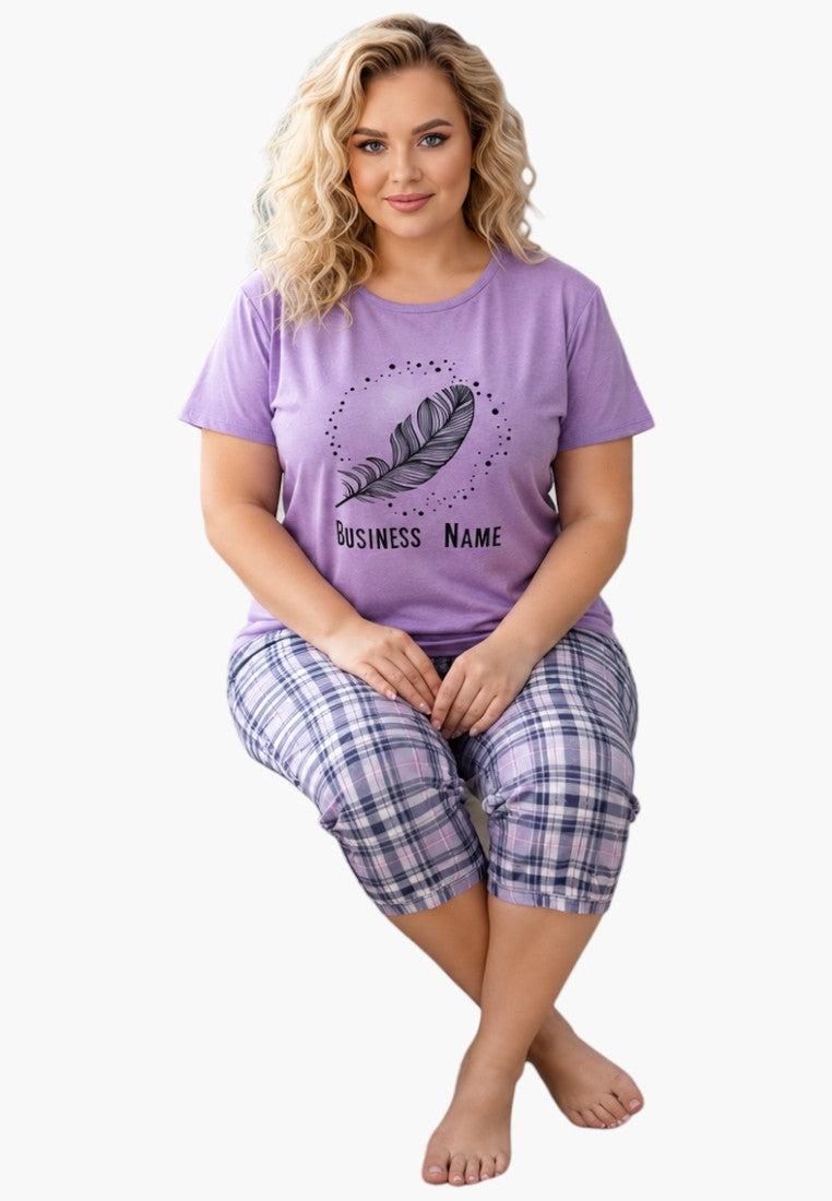 Lifestyle shot of a woman in purple pajamas with plaid pants.