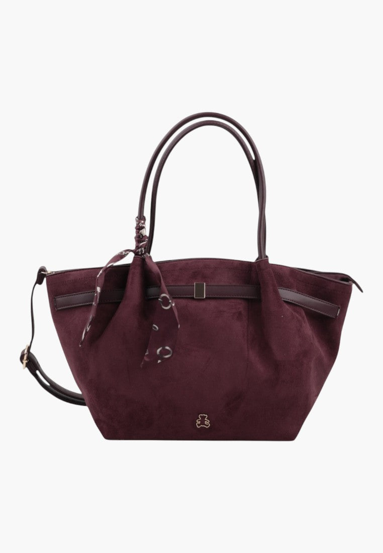 Side view of a large burgundy faux suede shopper bag with a detachable strap.