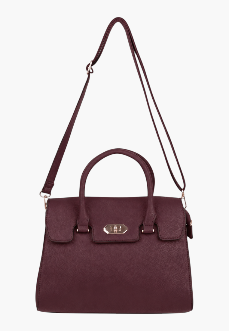 Back view of a burgundy handbag featuring an adjustable strap and gold hardware against a white background.