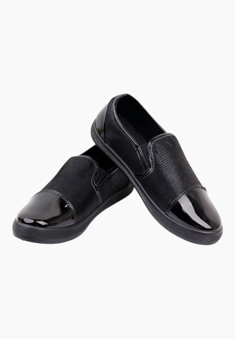 Side view of black slip-on shoes showcasing a minimalist style and smooth finish.