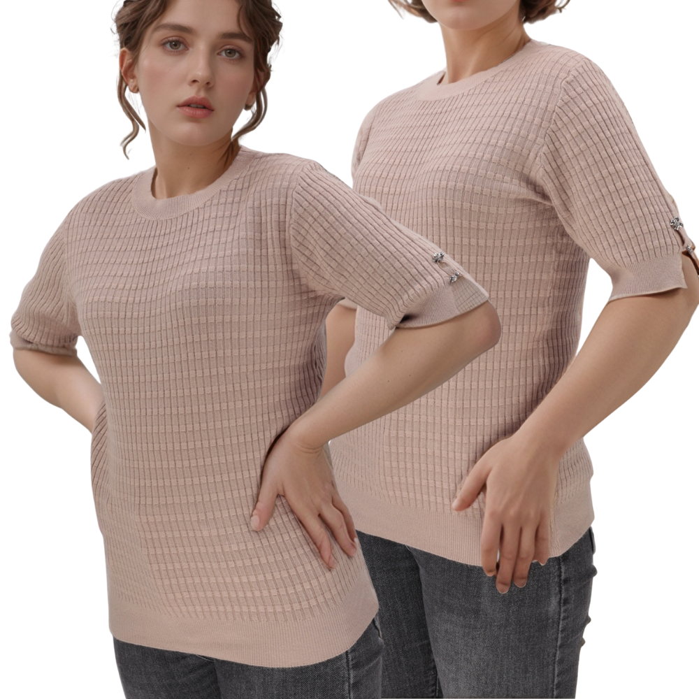 Lifestyle shot of a light pink top with short sleeves and textured fabric.