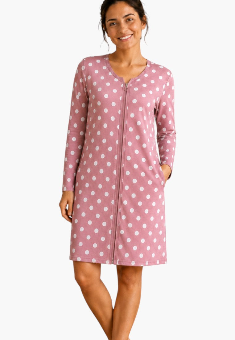 Lifestyle shot of a pink polka dot robe with long sleeves and side pockets.