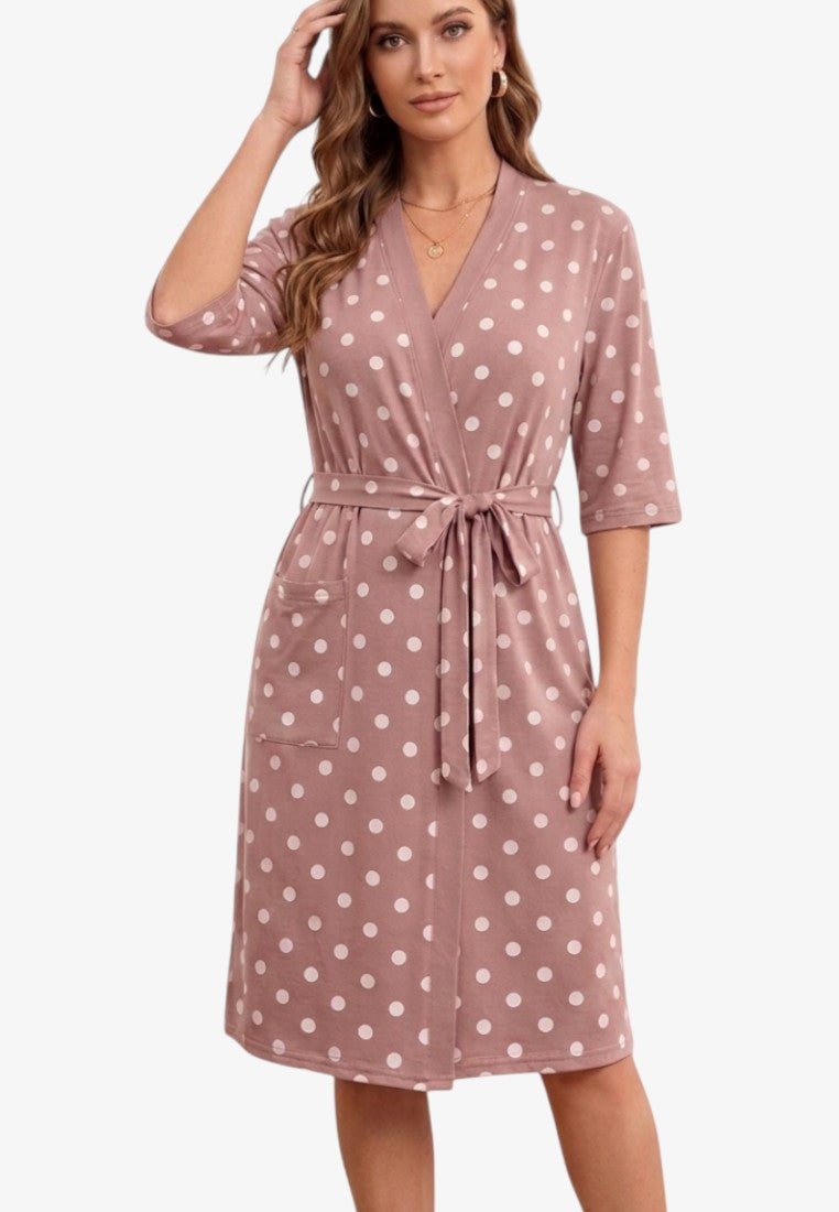 Front view of a dusty pink cotton robe with white polka dots, featuring short sleeves and pockets.