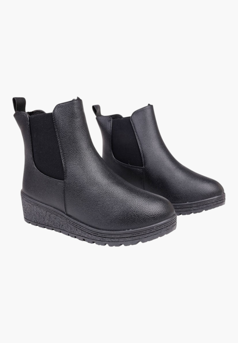 Front view of black ankle boots with elastic side panels on a white background.
