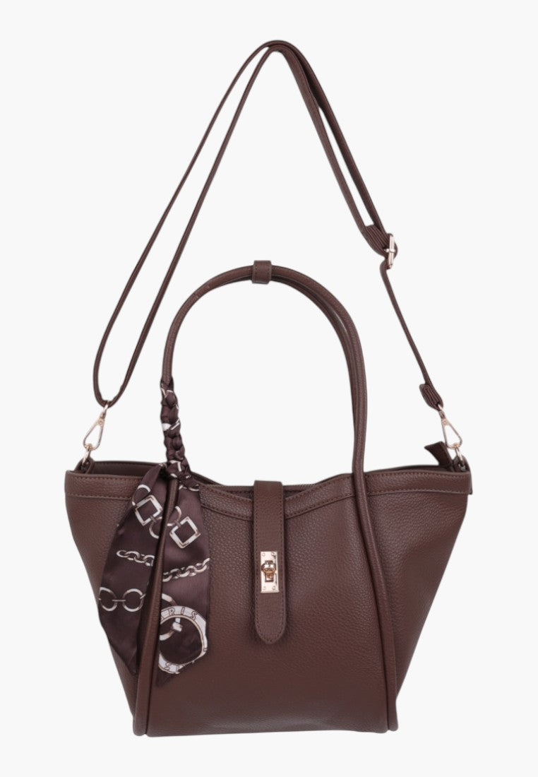 Detail view of taupe faux leather shopper bag with braided handle and interior pocket.